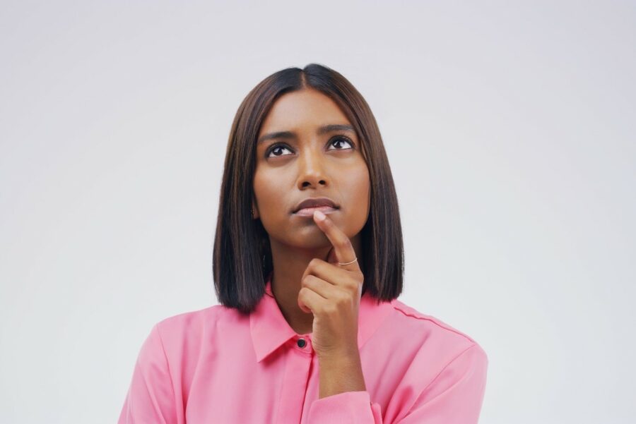 A woman looks upward pensively