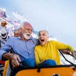 A man and a woman riding on a roller coaster